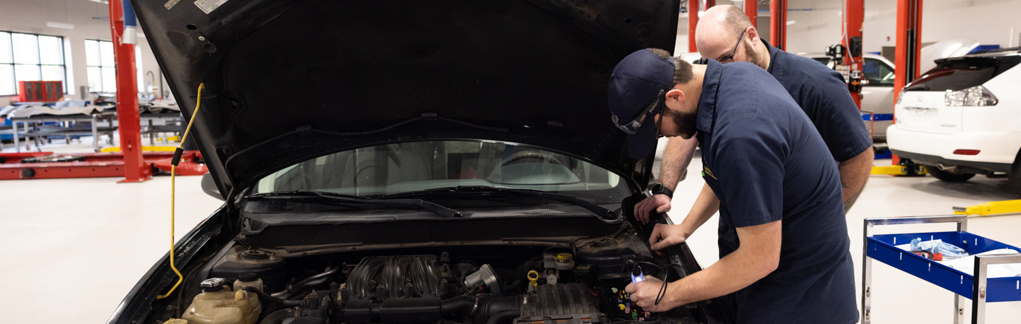 Automotive Technology students at FDTC work on a car in the automotive building shop