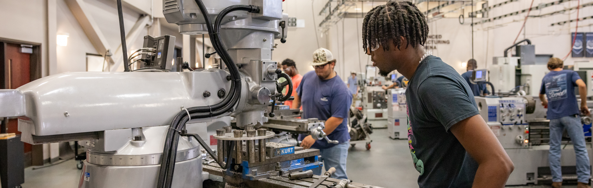 Machine Tool Technology students work on manufacturing machines