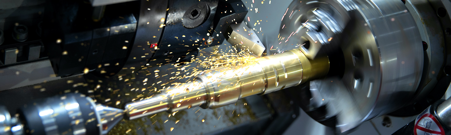 A metal lathe cutting a production part.