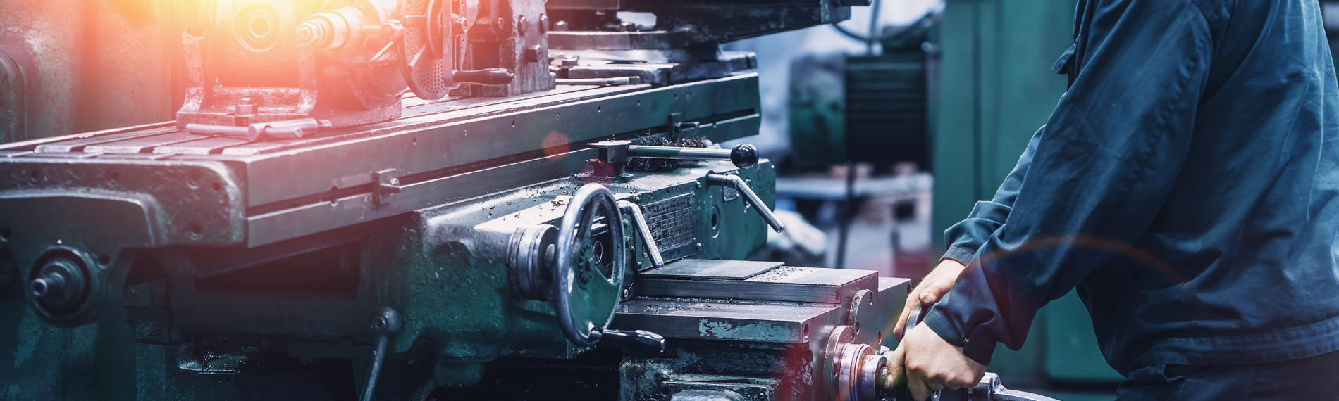 A student operates a metal lathe.