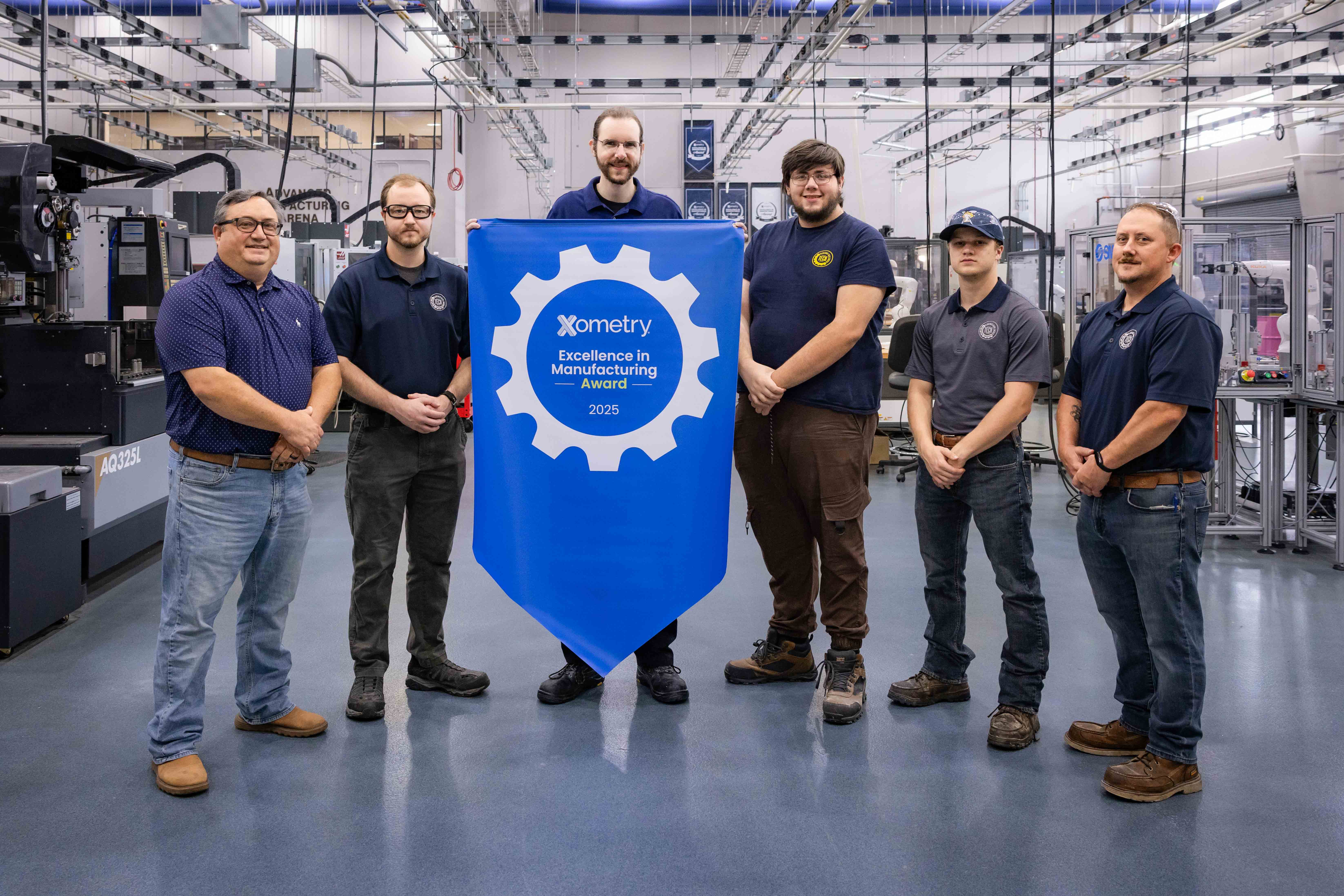 The SiMT Manufacturing team is lined up with a manufacturing excellence award.