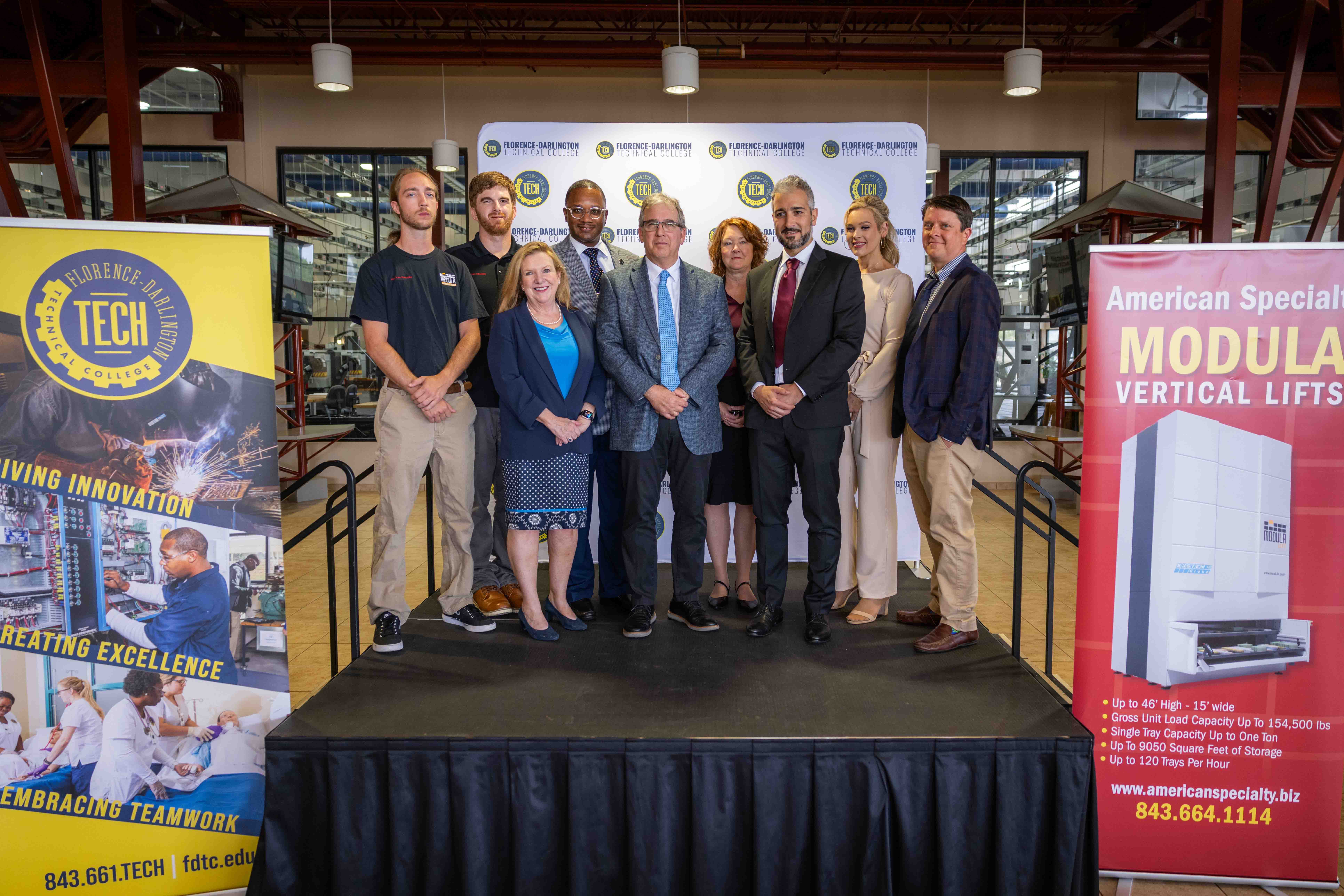 A group of professionals posing for a photo at the Modula Donation Event.