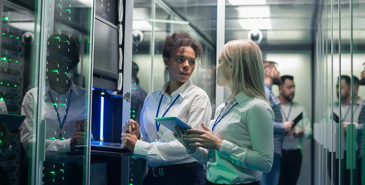 Two female cyber security professionals work at a computer