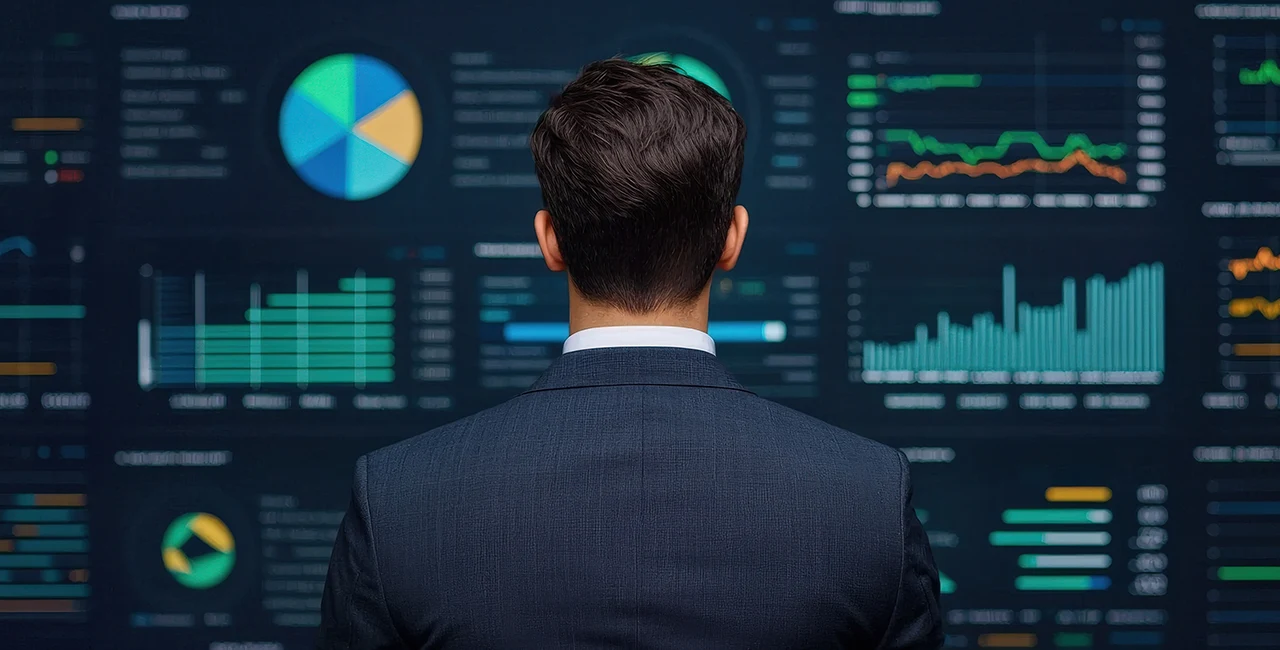 an executive views a wall of data dashboards