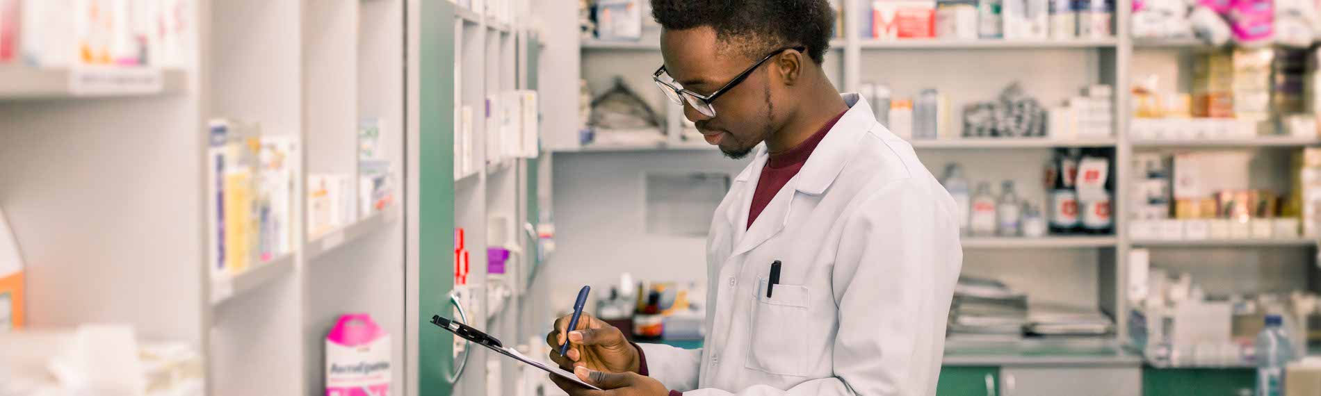 A pharmacy technician takes inventory of medication.