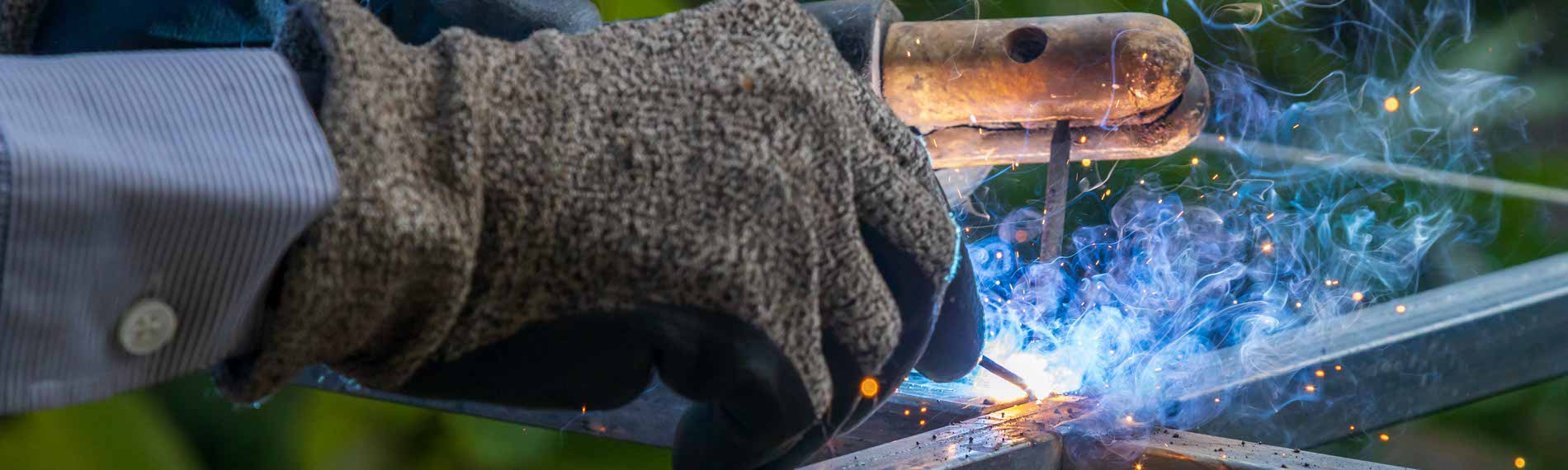 A stick welder welding metal together.