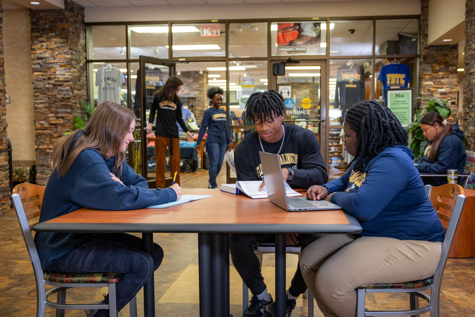 FDTC students doing school work in front of the FDTC Bookstore.